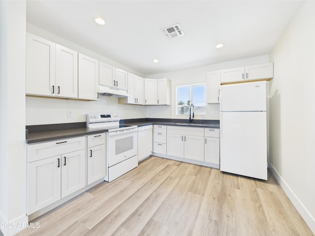 1917 E Monroe St, Phoenix, AZ 85034 - kitchen with white appliances, under cabinet range hood, a sink, dark countertops, and light wood-type flooring