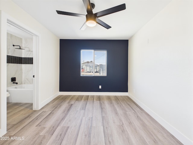 1917 E Monroe St, Phoenix, AZ 85034 - unfurnished room with wood finished floors, a ceiling fan, and baseboards