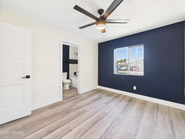 1917 E Monroe St, Phoenix, AZ 85034 - unfurnished bedroom featuring wood finished floors, baseboards, ensuite bathroom, and a ceiling fan