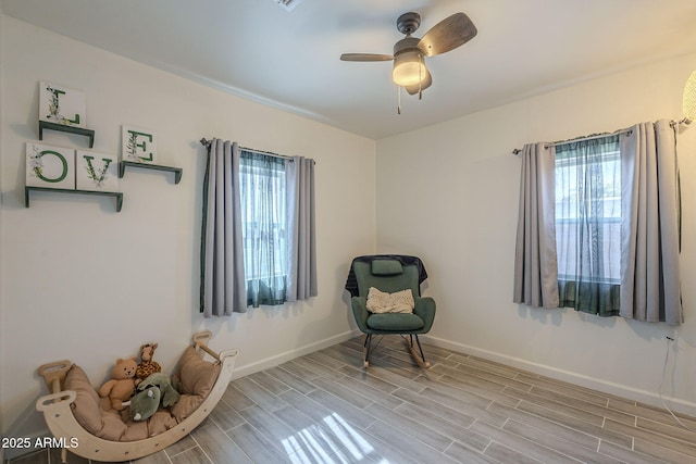 sitting room with ceiling fan and a healthy amount of sunlight