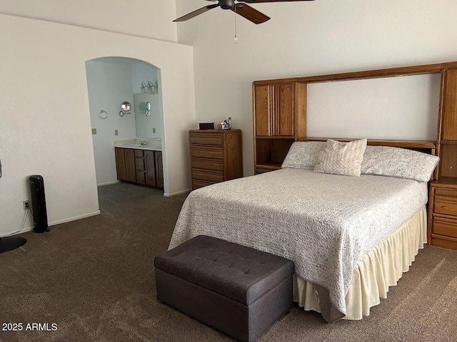 8981 W Tuckey Ln, Glendale, AZ 85305 - bedroom with dark carpet, arched walkways, a towering ceiling, baseboards, and ceiling fan