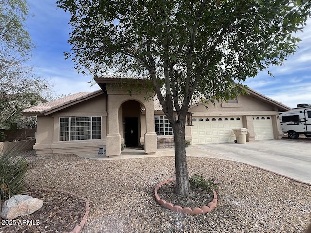8981 W Tuckey Ln, Glendale, AZ 85305 - mediterranean / spanish-style home featuring stucco siding, concrete driveway, and a garage