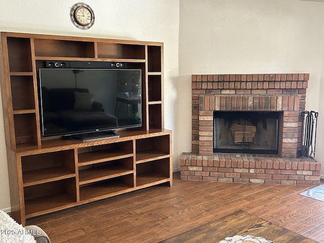 8981 W Tuckey Ln, Glendale, AZ 85305 - living area with dark wood-style flooring and a brick fireplace