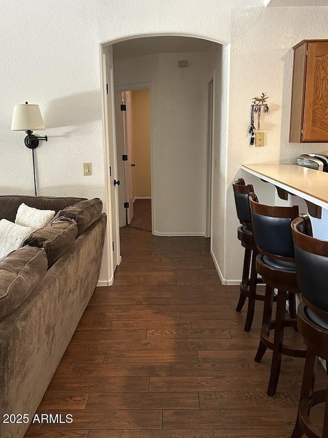 8981 W Tuckey Ln, Glendale, AZ 85305 - corridor with dark wood-type flooring, arched walkways, and baseboards