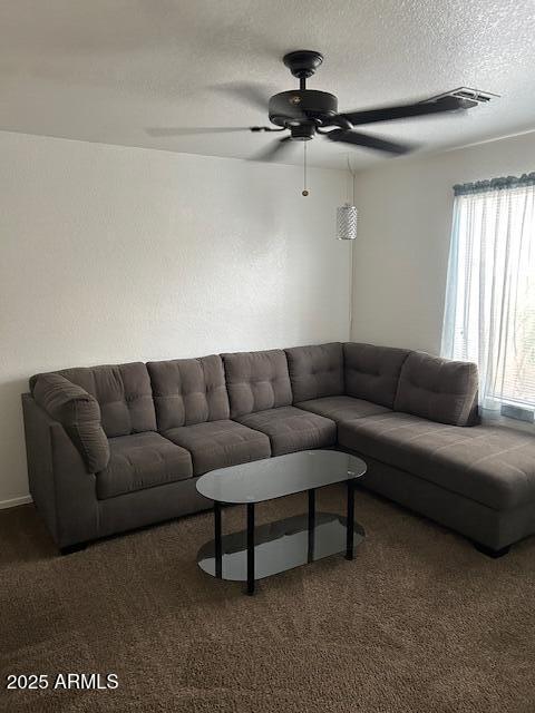 8981 W Tuckey Ln, Glendale, AZ 85305 - living room featuring ceiling fan, carpet floors, and a textured ceiling