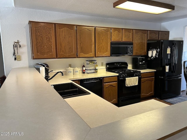 8981 W Tuckey Ln, Glendale, AZ 85305 - kitchen with black appliances, a sink, and light countertops