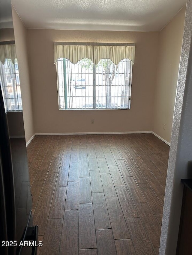 8981 W Tuckey Ln, Glendale, AZ 85305 - empty room featuring wood finished floors and healthy amount of natural light