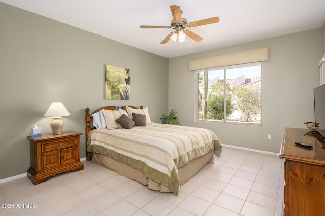 bedroom with light tile patterned floors, ceiling fan, and baseboards