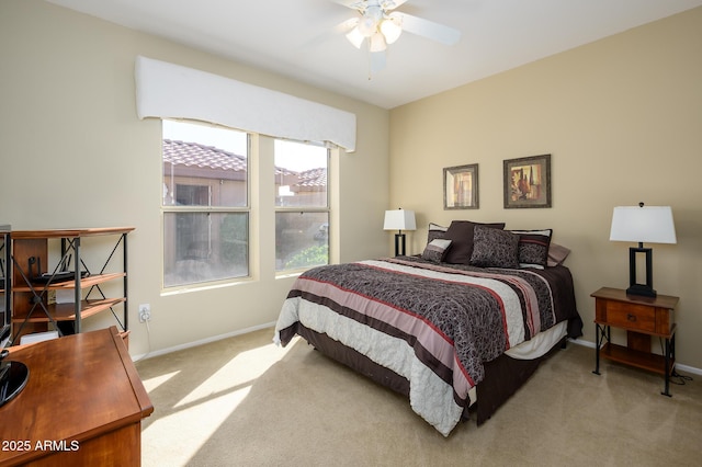 bedroom with light carpet, ceiling fan, and baseboards