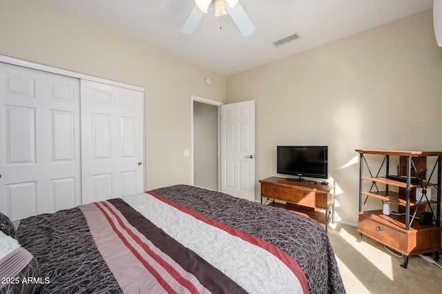 carpeted bedroom featuring a closet, visible vents, and ceiling fan