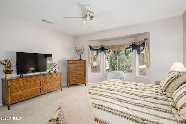 bedroom featuring light carpet, baseboards, visible vents, and a ceiling fan