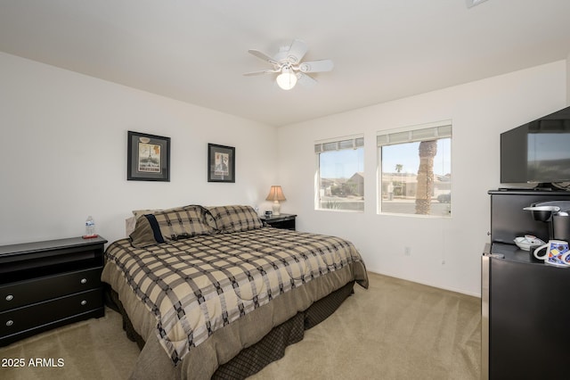 bedroom with ceiling fan and light colored carpet