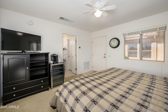 bedroom featuring beverage cooler, ceiling fan, visible vents, and light colored carpet