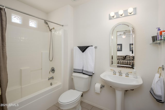 bathroom with toilet, tile patterned flooring, baseboards, and shower / tub combo with curtain