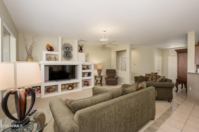 living area with visible vents, a ceiling fan, and light tile patterned flooring