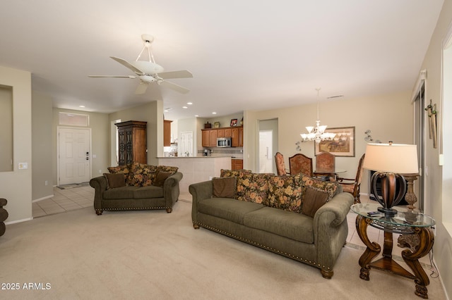 living room with light tile patterned floors, recessed lighting, light colored carpet, baseboards, and ceiling fan with notable chandelier