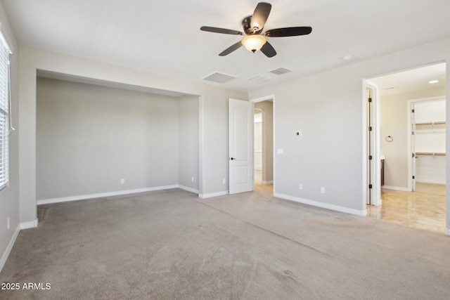 unfurnished room with ceiling fan and light carpet