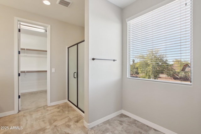 bathroom with a shower with door