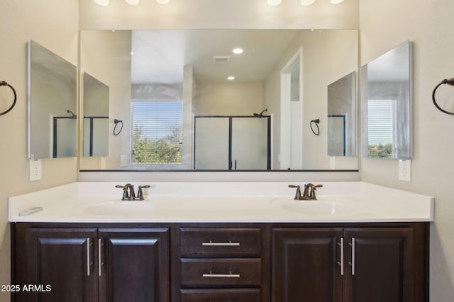 bathroom featuring walk in shower and vanity