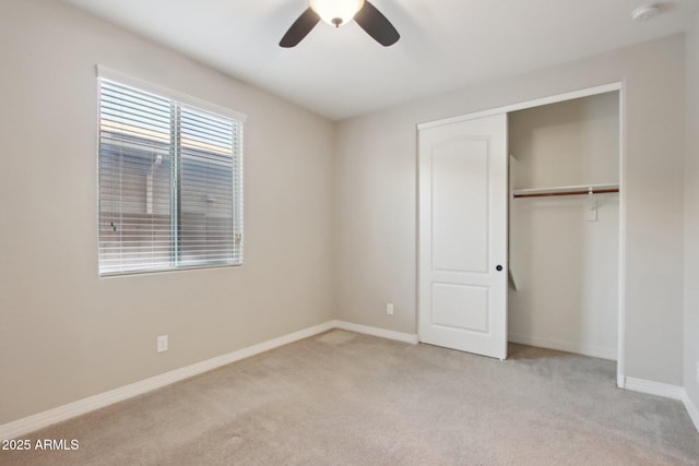 unfurnished bedroom featuring ceiling fan, a closet, and light carpet