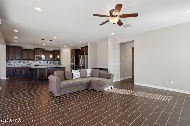 living room with sink and ceiling fan