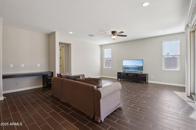 living room with ceiling fan and plenty of natural light