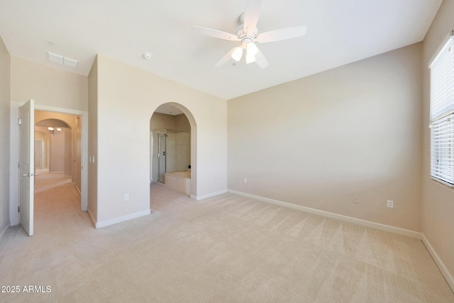 20750 N 87th St Unit 2062, Scottsdale, AZ 85255 - spare room featuring arched walkways, a ceiling fan, light carpet, and baseboards