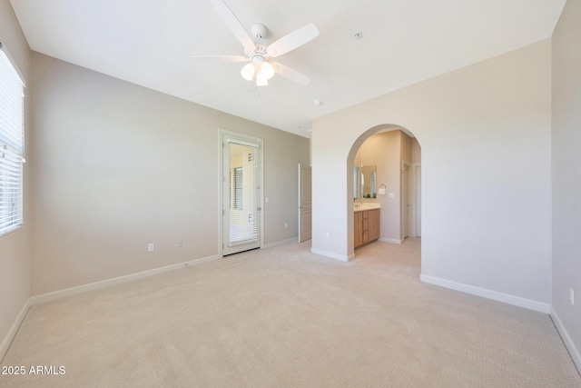 20750 N 87th St Unit 2062, Scottsdale, AZ 85255 - unfurnished bedroom with arched walkways, light colored carpet, baseboards, and a ceiling fan
