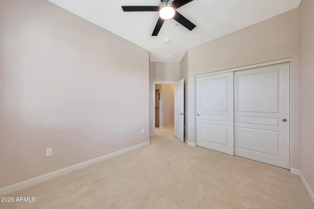20750 N 87th St Unit 2062, Scottsdale, AZ 85255 - unfurnished bedroom featuring light colored carpet, baseboards, vaulted ceiling, a closet, and a ceiling fan