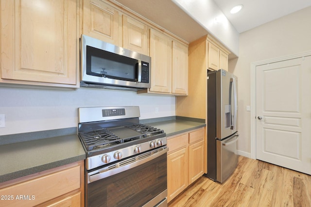 20750 N 87th St Unit 2062, Scottsdale, AZ 85255 - kitchen featuring stainless steel appliances, light brown cabinetry, dark countertops, light wood-style floors, and recessed lighting