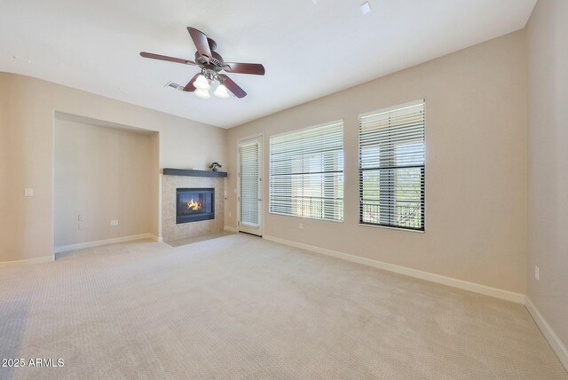 20750 N 87th St Unit 2062, Scottsdale, AZ 85255 - unfurnished living room with baseboards, light carpet, a tile fireplace, and ceiling fan