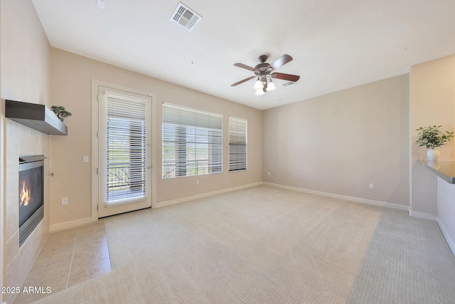 20750 N 87th St Unit 2062, Scottsdale, AZ 85255 - unfurnished living room with a tile fireplace, ceiling fan, light colored carpet, and baseboards