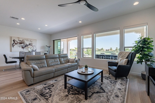 living room featuring ceiling fan and light wood-type flooring