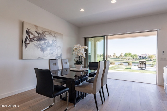 dining space with hardwood / wood-style floors