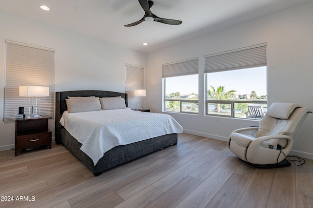 bedroom with ceiling fan and light wood-type flooring