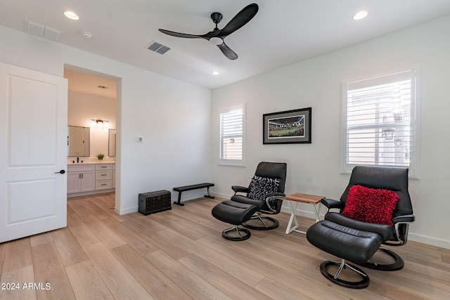 sitting room featuring light hardwood / wood-style floors and ceiling fan