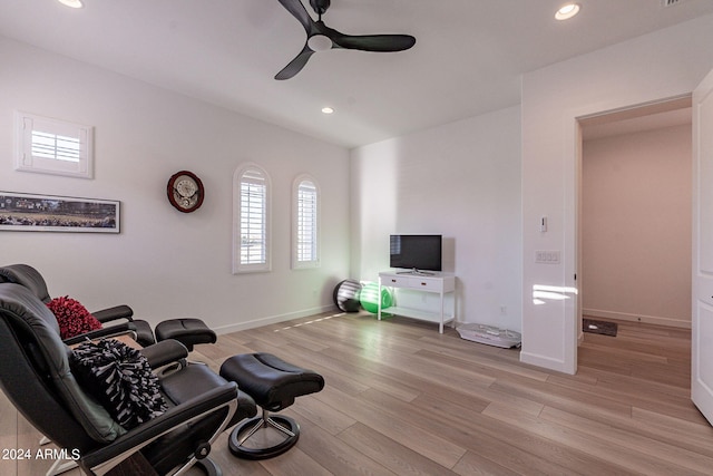 living room featuring ceiling fan and light wood-type flooring