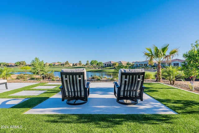 view of home's community with a water view and a lawn