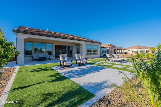 back of house with a patio area, a lawn, and an outdoor hangout area