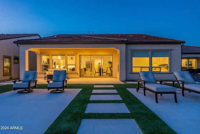 rear view of property with a patio area, an outdoor hangout area, and a lawn