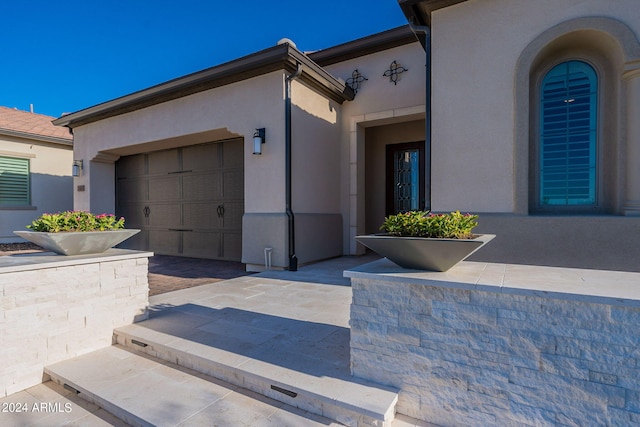 doorway to property featuring a garage