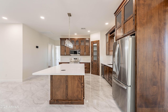 kitchen featuring a center island, hanging light fixtures, and appliances with stainless steel finishes