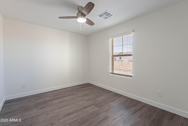 spare room featuring ceiling fan and dark hardwood / wood-style floors