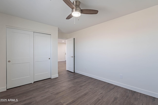 unfurnished bedroom with hardwood / wood-style flooring, ceiling fan, and a closet