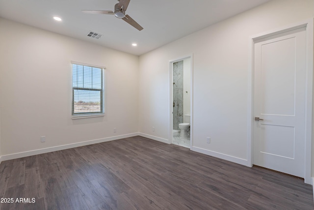 spare room featuring dark hardwood / wood-style floors and ceiling fan