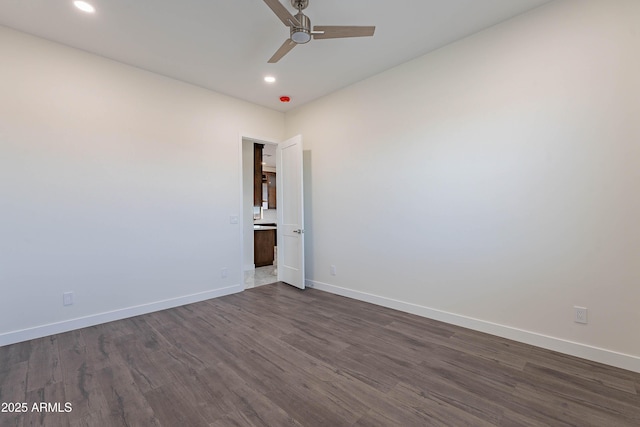 unfurnished room with ceiling fan and dark hardwood / wood-style floors