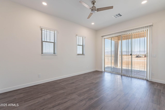 empty room featuring ceiling fan and dark wood-type flooring