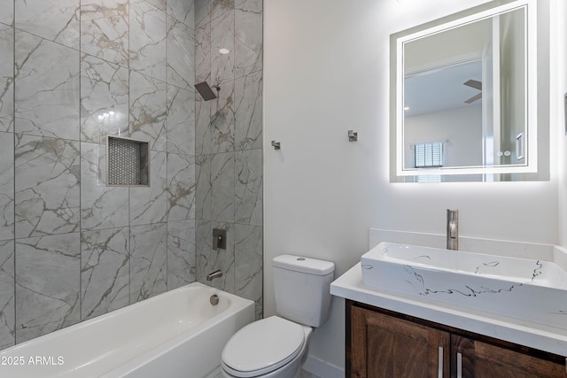 full bathroom featuring vanity, toilet, and tiled shower / bath combo