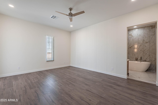 unfurnished room featuring ceiling fan and dark hardwood / wood-style flooring