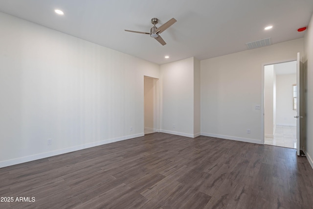 empty room featuring ceiling fan and dark hardwood / wood-style flooring